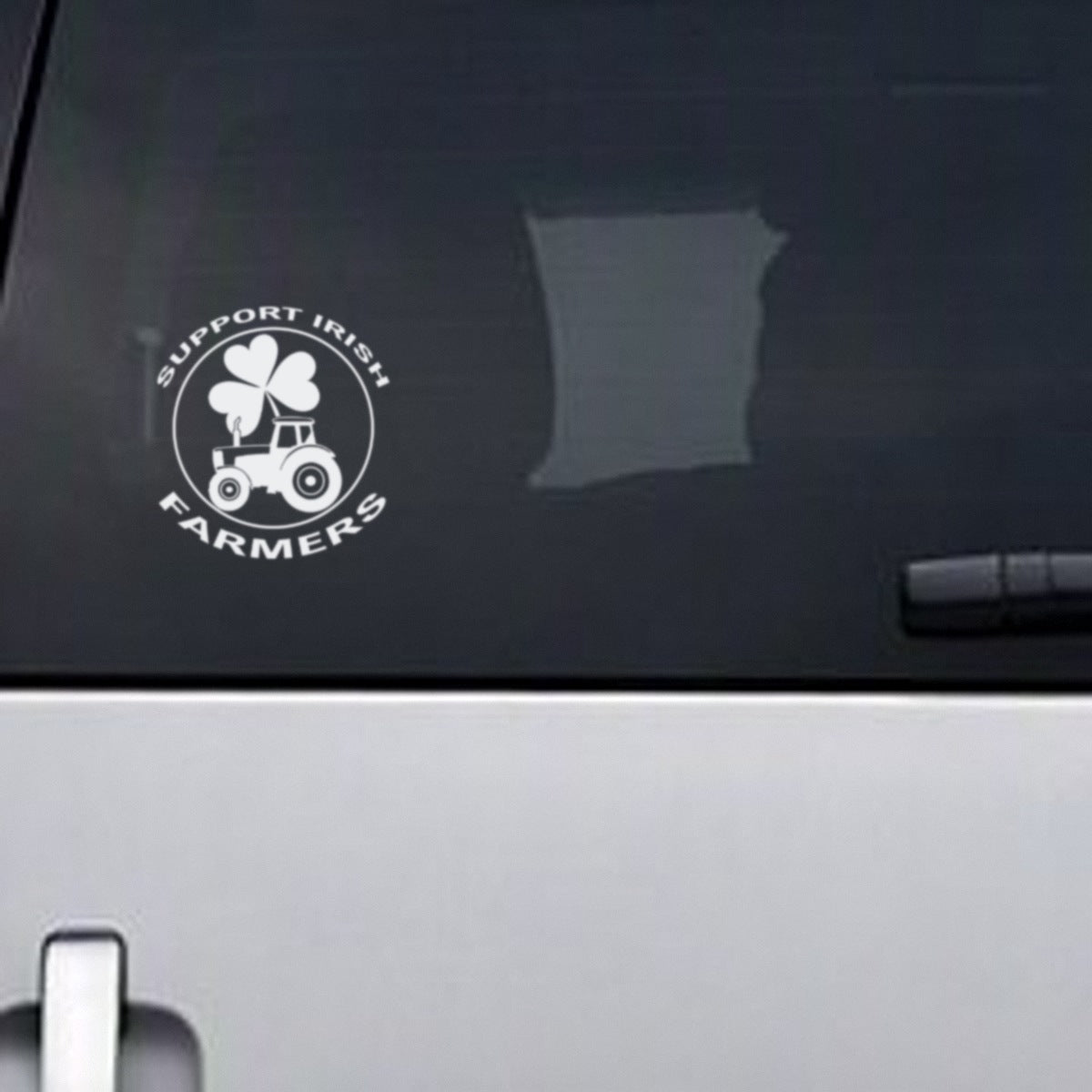 Support Irish Farmers white vinyl decal, about 13.5cm wide, on a vehicle rear window
