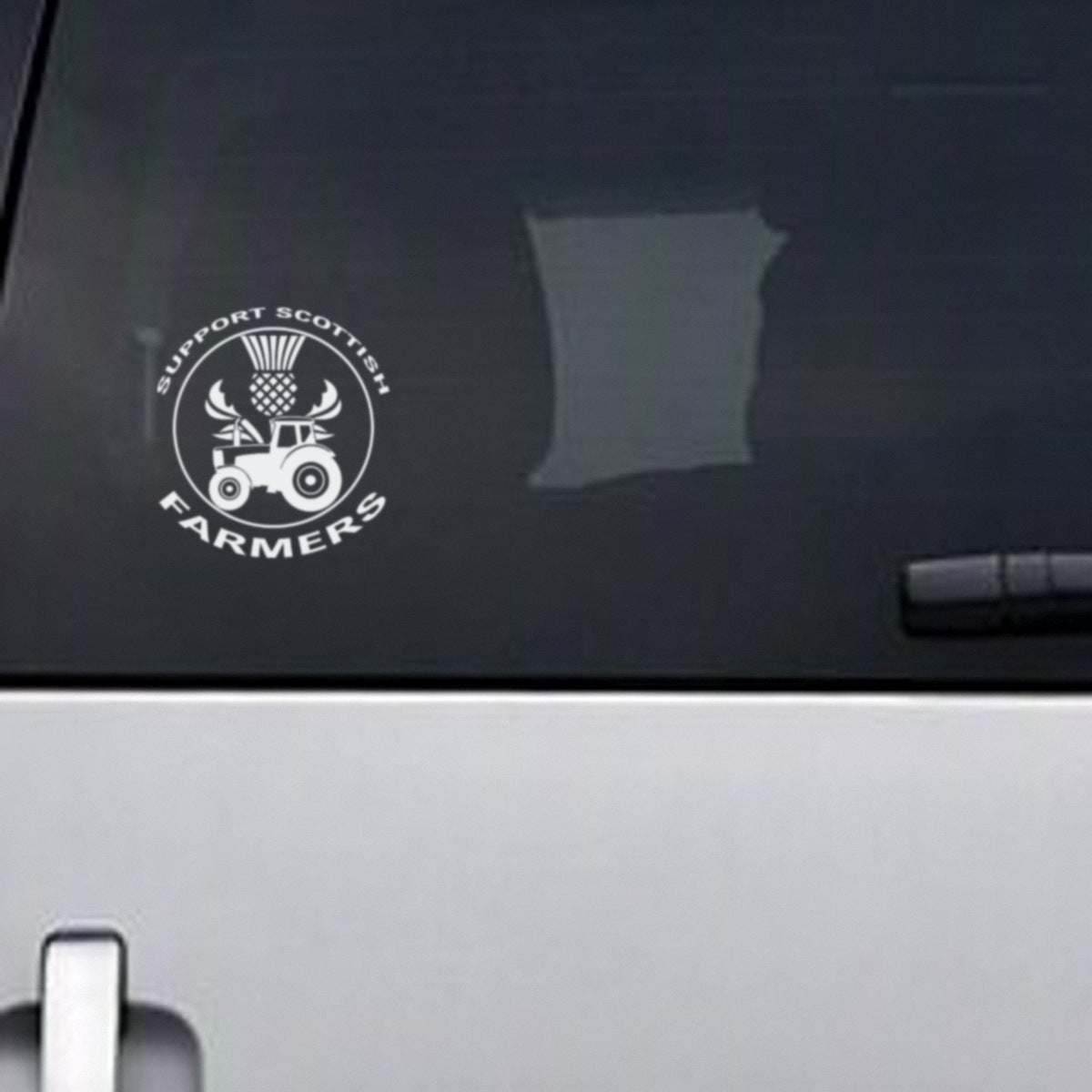 Support Scottish Farmers white vinyl decal, about 13.5cm wide, on a vehicle rear window